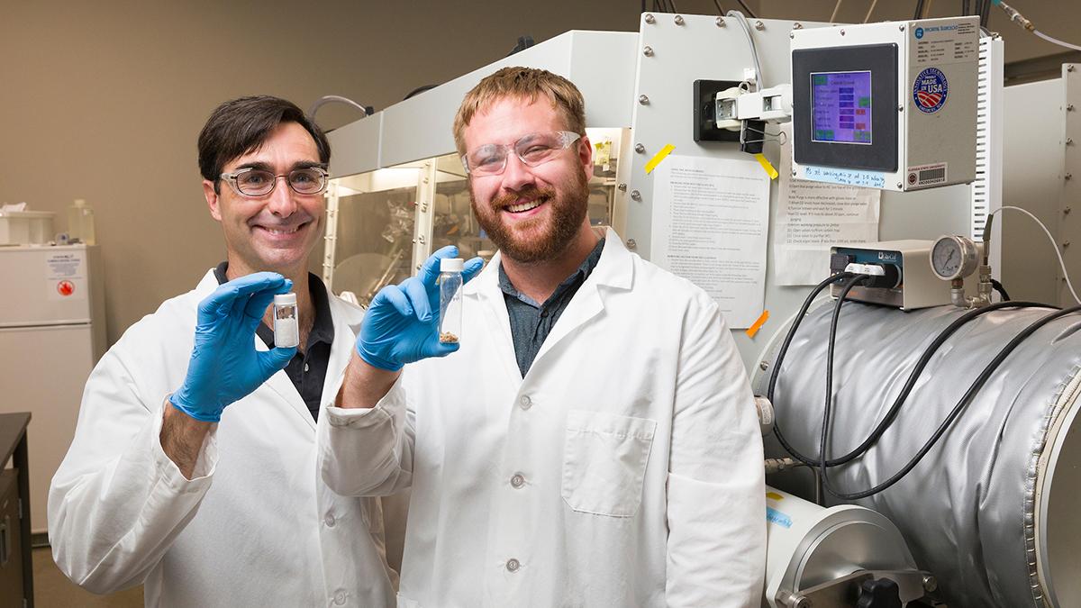 photo of daniel hallinan and michael patric blatt holding test tubes in lab at famu-fsu engineering