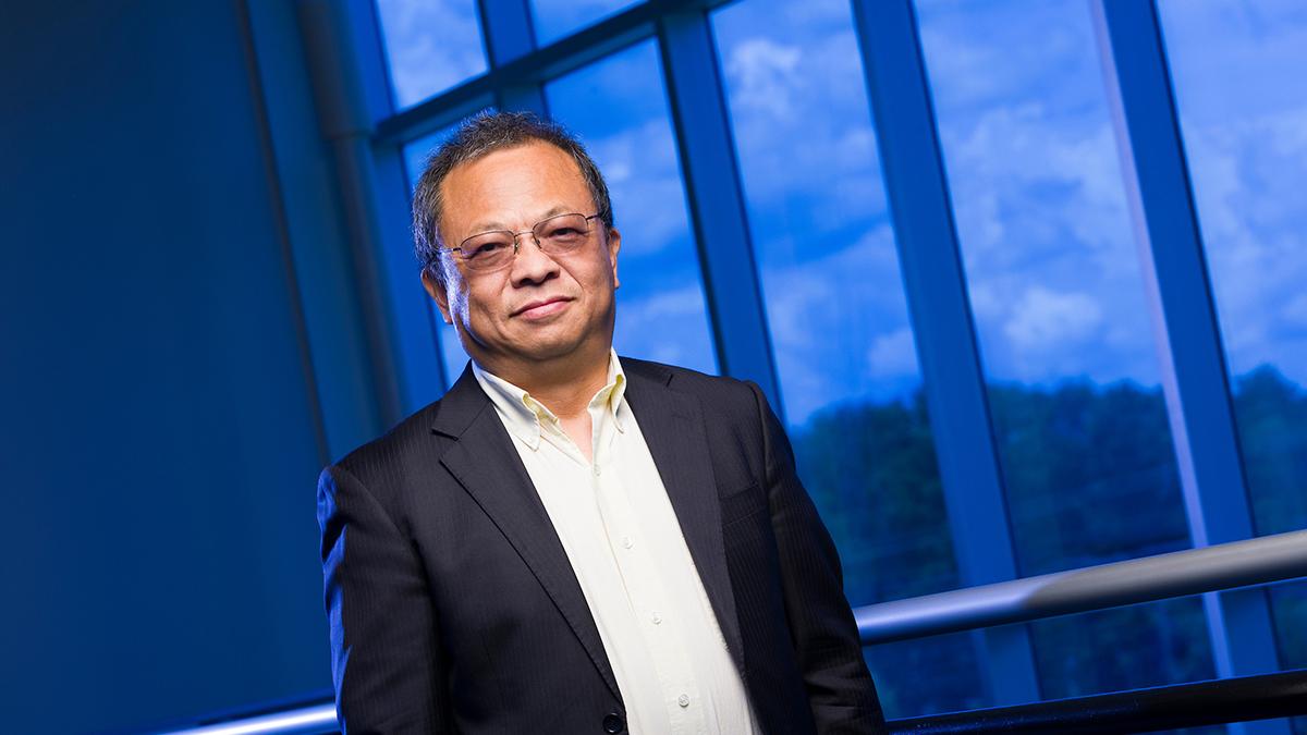 portrait of richard liang at famu-fsu engineering in front of blue window