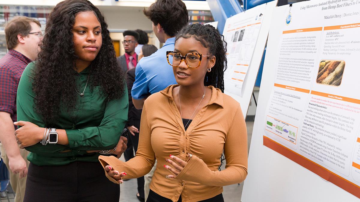 two black engineering students at a poster session at famu-fsu engineering