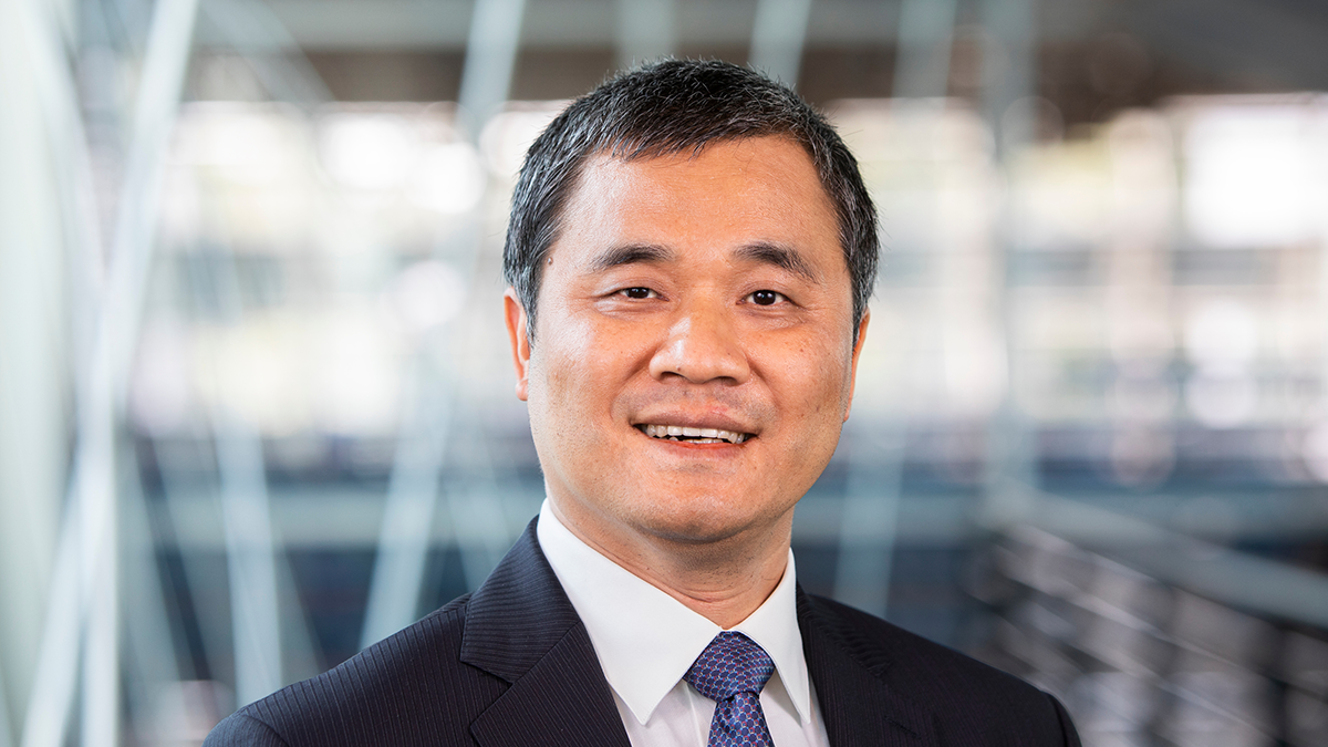 smiling man in black suit