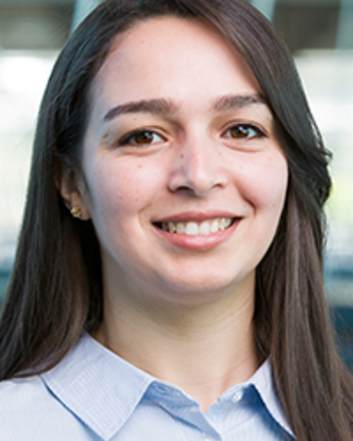 smiling woman with long dark hair and blue shirt