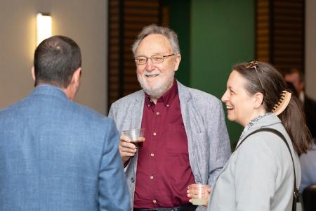 photo of people talking with drinks in hand