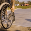 closeup photo of wheelchair going across span path bridge