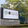 photo of famu-fsu engineering sign with trees and blue sky