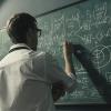 professor doing math on a chalkboard
