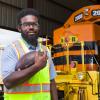 photo of famu-fsu engineering alumni philip sylvester holding football in front of train