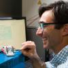 photo of famu-fsu engineering professor daniel hallinan working in lab and smiling