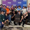 phot of a group of students with a trophy in front of an IEEE background
