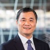 smiling man in black suit
