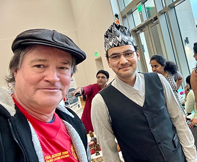 photo of engineering undergrad aashutosh pokharel with fsu graduate school dean mark riley at international festival
