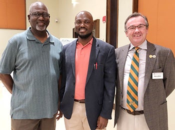 Associate professor Tarik Dickens with his father on left and engineering Dean Murray Gibson on right