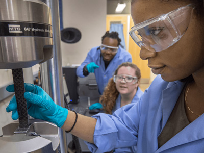 3 students working in a research lab