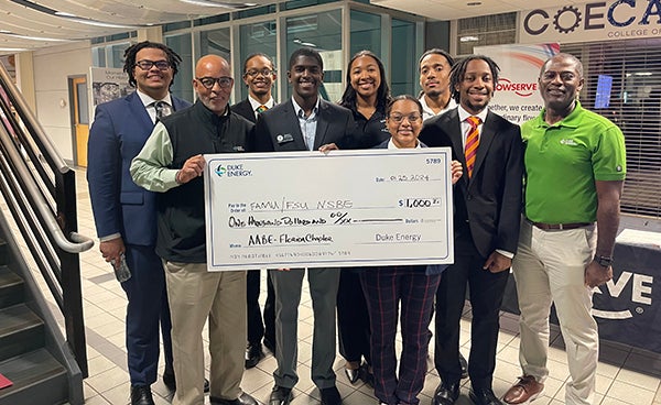 photo of nsbe students accepting a check from duke energy at the famu-fsu college of engineering